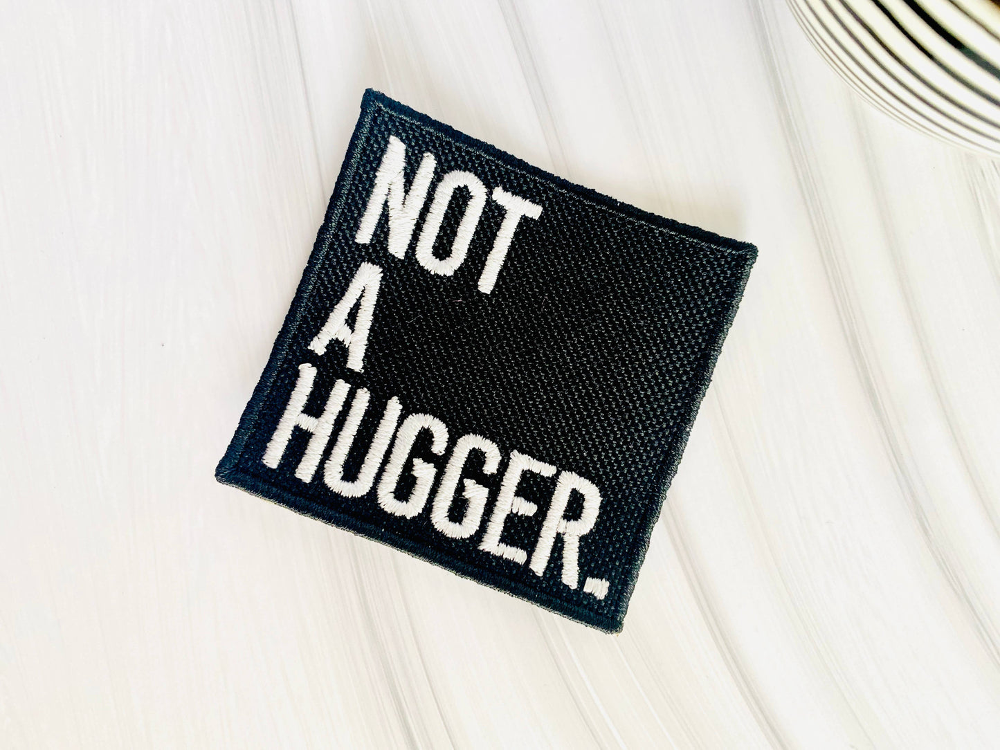Not a hugger embroidered iron-on hat patch