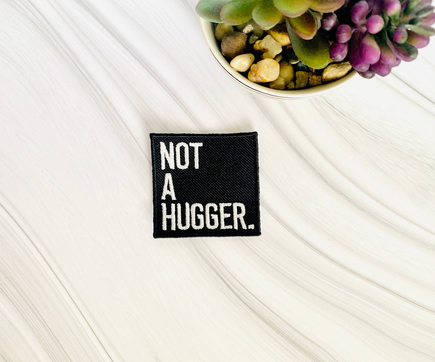 Not a hugger embroidered iron-on hat patch