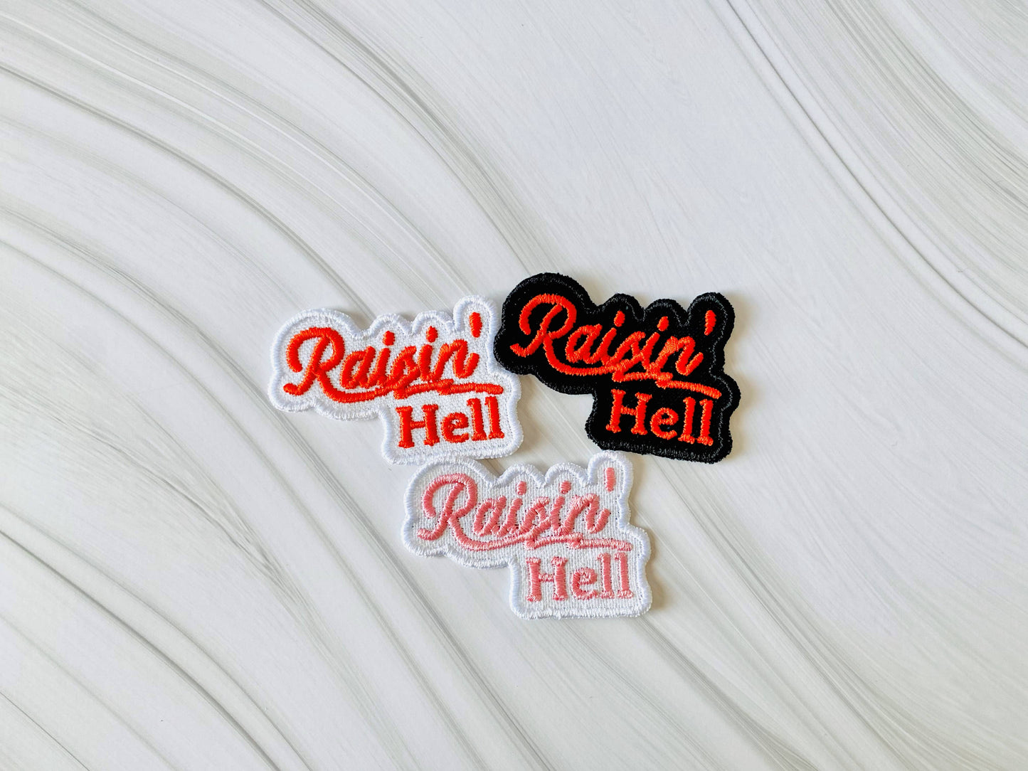 Raisin' hell embroidered iron-on hat patch