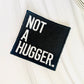 Not a hugger embroidered iron-on hat patch